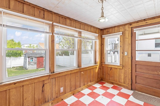 552 Dix St, Manchester, NH 03103 - unfurnished sunroom with tile patterned floors, wood walls, baseboards, and an ornate ceiling