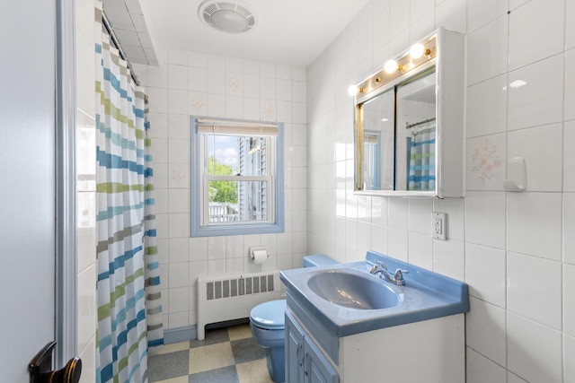 552 Dix St, Manchester, NH 03103 - full bath with radiator heating unit, tile walls, tile patterned floors, vanity, and toilet