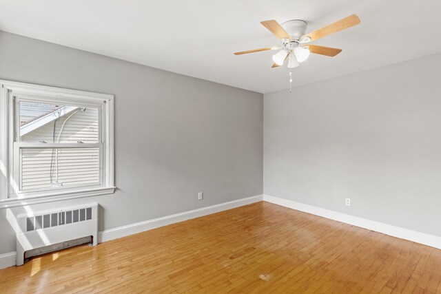552 Dix St, Manchester, NH 03103 - unfurnished room featuring radiator heating unit, wood finished floors, baseboards, and ceiling fan