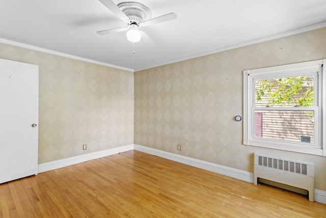 552 Dix St, Manchester, NH 03103 - unfurnished room with radiator heating unit, light wood-style flooring, ceiling fan, and crown molding