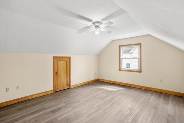 552 Dix St, Manchester, NH 03103 - additional living space featuring light wood-type flooring, baseboards, lofted ceiling, and a ceiling fan