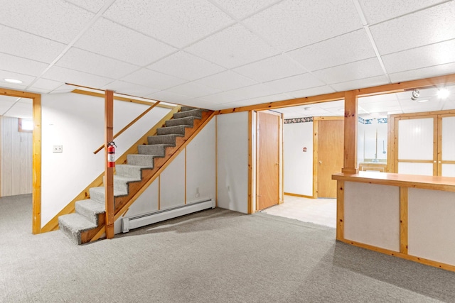 552 Dix St, Manchester, NH 03103 - finished below grade area with a baseboard heating unit, stairway, carpet, a drop ceiling, and baseboards
