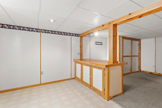 552 Dix St, Manchester, NH 03103 - finished basement with baseboards, a paneled ceiling, and light floors