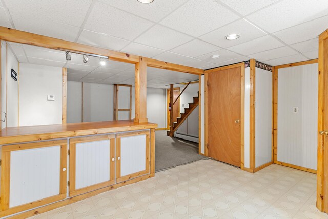 552 Dix St, Manchester, NH 03103 - finished basement with light floors, baseboard heating, a drop ceiling, and stairway