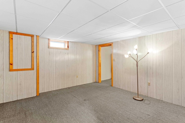 552 Dix St, Manchester, NH 03103 - basement featuring carpet, wood walls, and a paneled ceiling