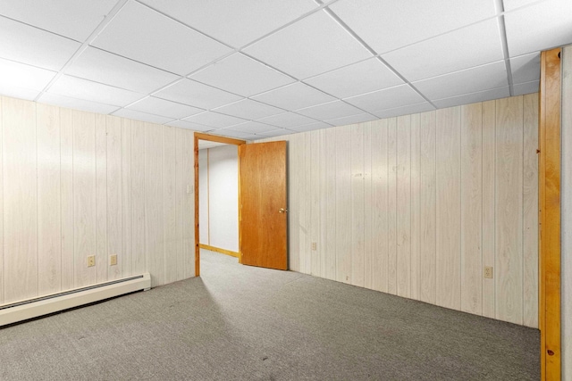 552 Dix St, Manchester, NH 03103 - empty room with carpet floors, baseboard heating, a paneled ceiling, and wood walls