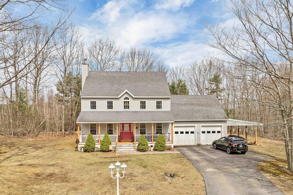 20 Lydia Ln, Milton, NH 03851 - country-style home with covered porch, an attached garage, asphalt driveway, and a front yard