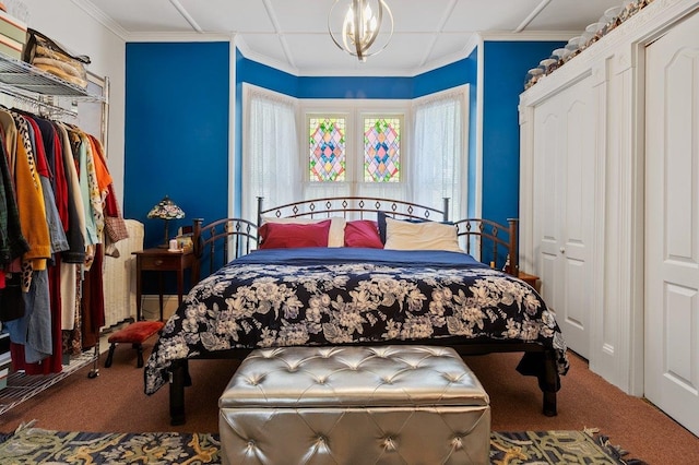 bedroom featuring carpet floors, a chandelier, and crown molding