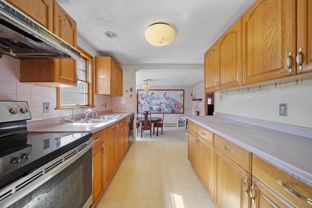 kitchen with stainless steel electric range oven, under cabinet range hood, a sink, light flooring, and light countertops