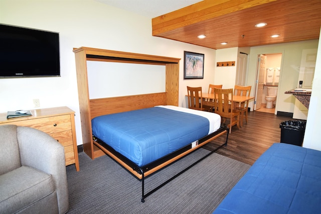 bedroom with recessed lighting, wood finished floors, and ensuite bathroom