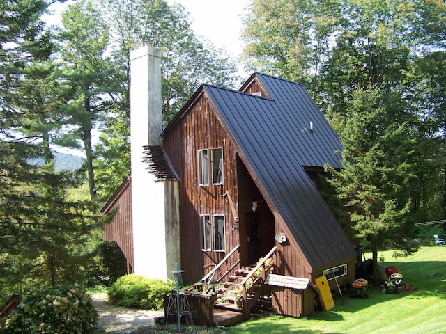 111 Forest Ln, Rochester, VT 05767 - view of front of house with a chimney, a front yard, metal roof, and a standing seam roof