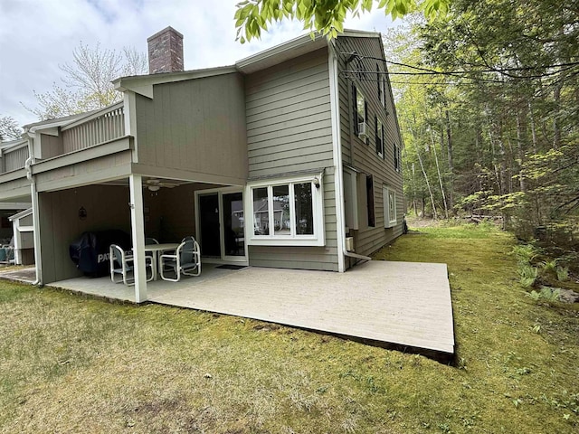 40-21 Harbor Way Unit 21, Wolfeboro, NH 03894 - back of house featuring a chimney, a patio, ceiling fan, and a yard