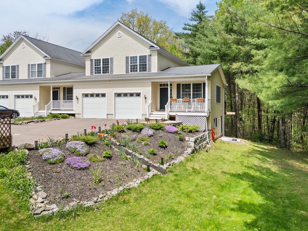 588 Rte 7 S Unit 102, Milton, VT 05468 - traditional-style house with covered porch, a garage, driveway, and a front lawn