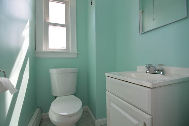 half bath with baseboards, toilet, vanity, and baseboard heating