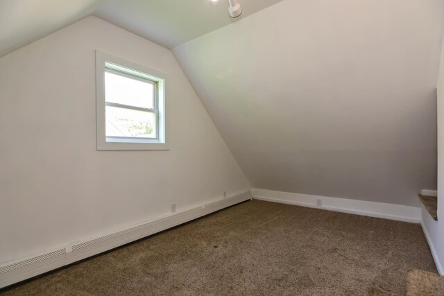 bonus room with a baseboard heating unit, carpet floors, vaulted ceiling, and baseboards