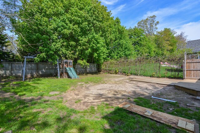 view of yard featuring a playground and fence