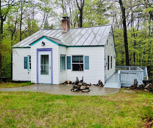 328 Main St Unit C, Andover, NH 03216 - back of property featuring a chimney, a deck, and a yard