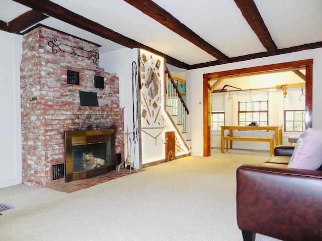 328 Main St Unit C, Andover, NH 03216 - living area with beamed ceiling, carpet flooring, stairway, and a fireplace