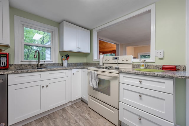 kitchen with white electric stove, a sink, light wood-style flooring, white cabinetry, and light stone counters
