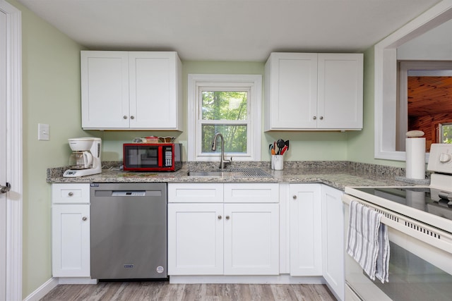 kitchen featuring stainless steel dishwasher, white electric range, a sink, light wood-type flooring, and white cabinets