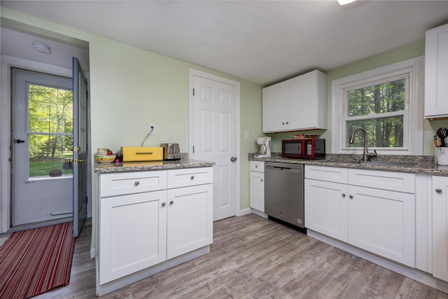 kitchen featuring stainless steel dishwasher, a sink, light wood-type flooring, white cabinets, and light stone countertops