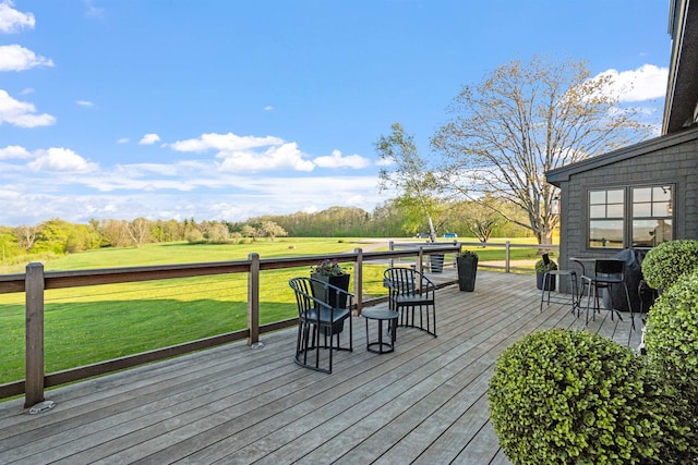 wooden deck featuring a lawn