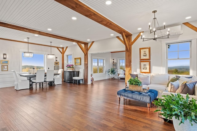 living room with beam ceiling, a chandelier, wood finished floors, and recessed lighting