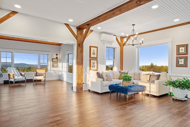 living area featuring a wall unit AC, beamed ceiling, a chandelier, recessed lighting, and wood finished floors