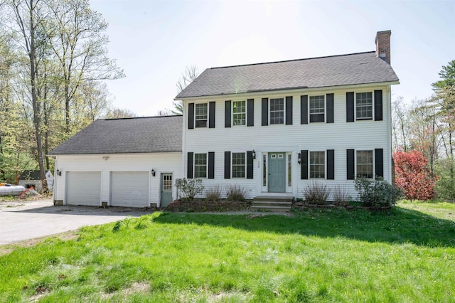 238 Slip Rd, Greenfield, NH 03047 - colonial-style house featuring a chimney, a garage, driveway, a front yard, and a shingled roof