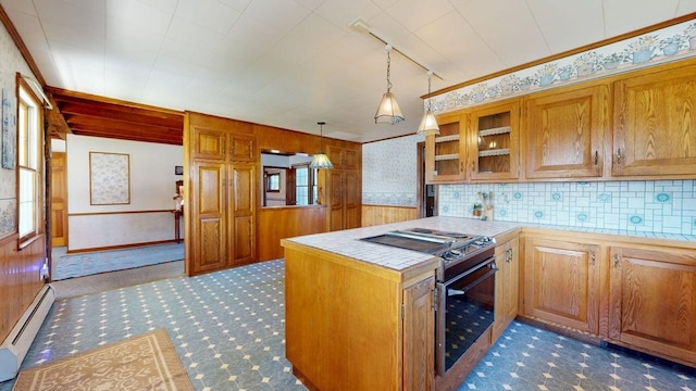 3005 Vt 78 Rte, Highgate, VT 05459 - kitchen featuring gas range oven, a baseboard heating unit, a peninsula, carpet flooring, and tile counters