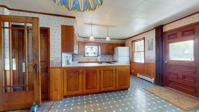 3005 Vt 78 Rte, Highgate, VT 05459 - kitchen featuring freestanding refrigerator, a baseboard heating unit, crown molding, wallpapered walls, and brown cabinetry