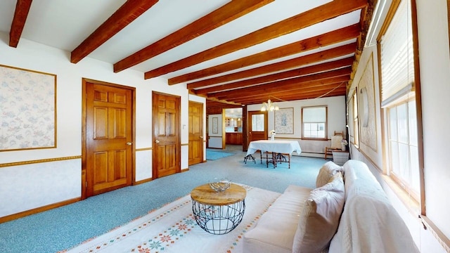 3005 Vt 78 Rte, Highgate, VT 05459 - carpeted living area with a chandelier, a baseboard radiator, beamed ceiling, and baseboards