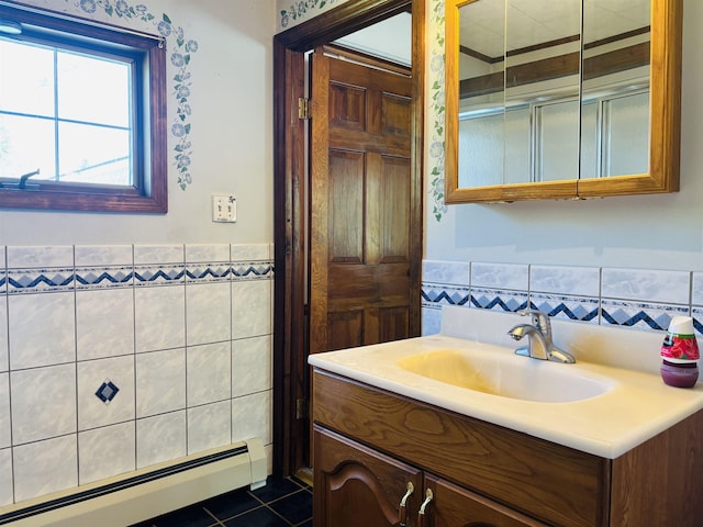 3005 Vt 78 Rte, Highgate, VT 05459 - bathroom featuring a baseboard radiator, tile walls, tile patterned floors, wainscoting, and vanity