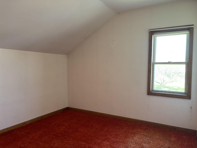 3005 Vt 78 Rte, Highgate, VT 05459 - additional living space with vaulted ceiling, plenty of natural light, dark colored carpet, and baseboards