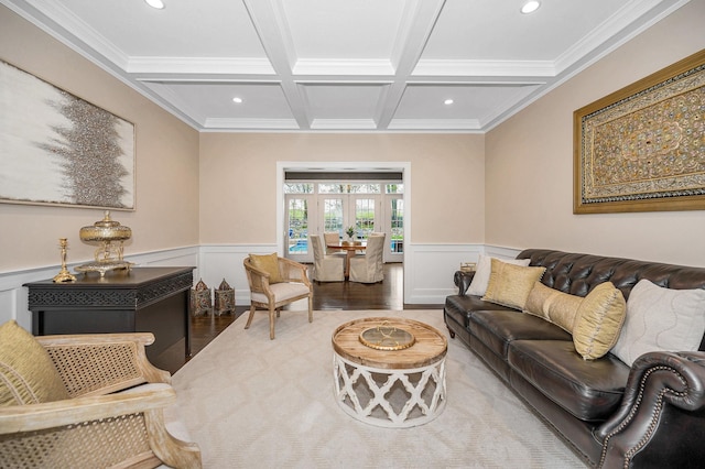 living area featuring coffered ceiling, beam ceiling, wood finished floors, recessed lighting, and wainscoting