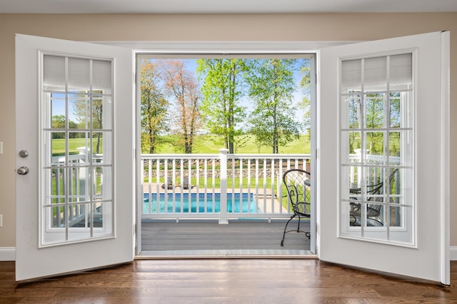 doorway featuring healthy amount of natural light and wood finished floors