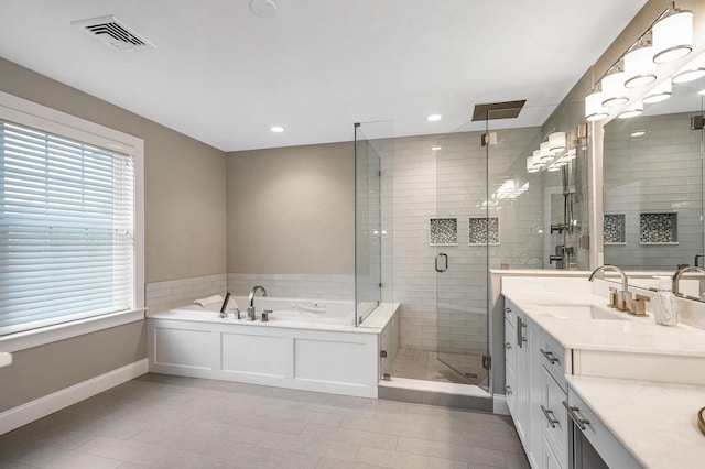 full bath featuring baseboards, double vanity, a shower stall, healthy amount of natural light, and recessed lighting