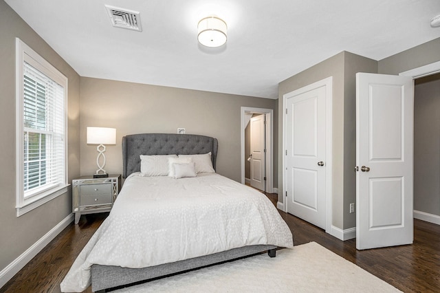 bedroom featuring baseboards and wood finished floors