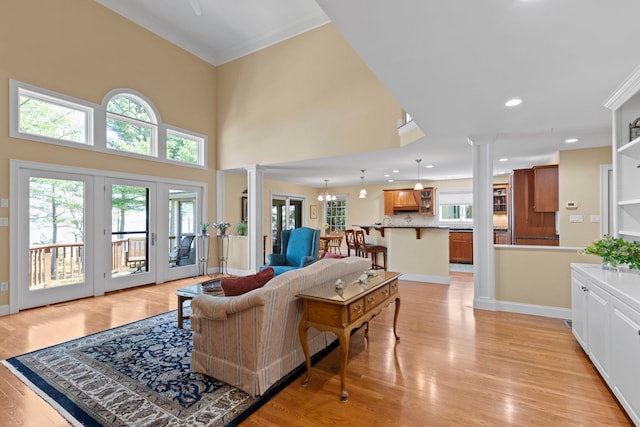 3 Osprey Ln, Newmarket, NH 03857 - living room with decorative columns, ornamental molding, plenty of natural light, light wood finished floors, and recessed lighting