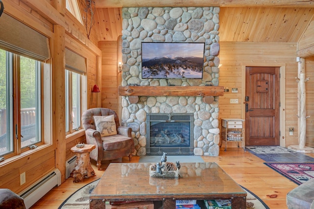 1481 Eaton Rd, Conway, NH 03813 - living area with a baseboard heating unit, hardwood / wood-style floors, wooden walls, wood ceiling, and a stone fireplace