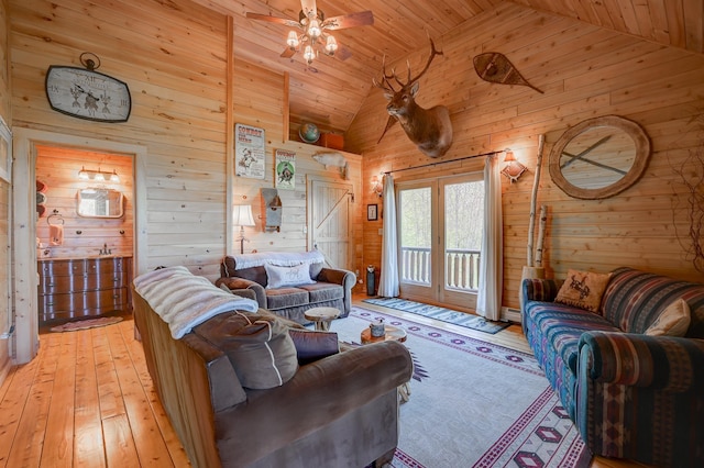 1481 Eaton Rd, Conway, NH 03813 - living area featuring wooden walls, light wood-style flooring, wood ceiling, ceiling fan, and high vaulted ceiling