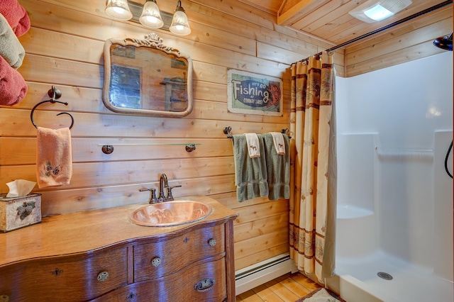 1481 Eaton Rd, Conway, NH 03813 - bathroom featuring a baseboard radiator, wood walls, a stall shower, vanity, and wood finished floors