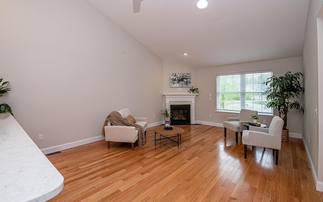 41 Winchester Dr, Hampstead, NH 03826 - sitting room featuring light wood-style floors, lofted ceiling, a glass covered fireplace, baseboards, and recessed lighting