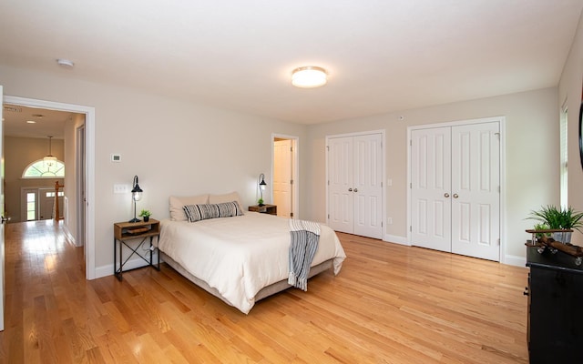 41 Winchester Dr, Hampstead, NH 03826 - bedroom with light wood-style floors, two closets, and baseboards