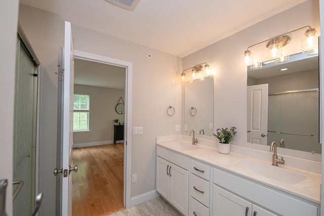 41 Winchester Dr, Hampstead, NH 03826 - full bathroom with double vanity, baseboards, and wood finished floors