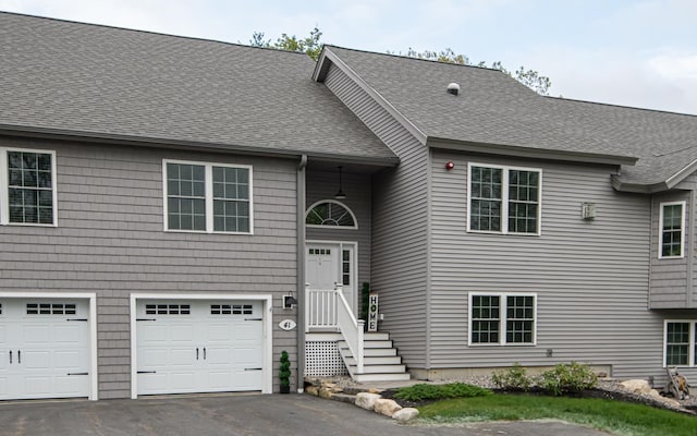 41 Winchester Dr, Hampstead, NH 03826 - view of front of house featuring an attached garage, asphalt driveway, and roof with shingles