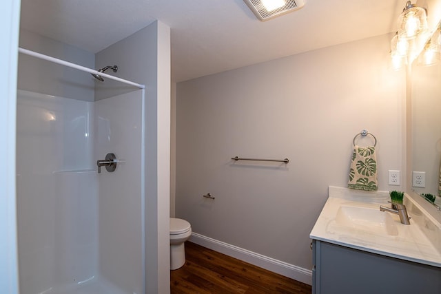 41 Winchester Dr, Hampstead, NH 03826 - bathroom featuring vanity, a shower, toilet, wood finished floors, and baseboards