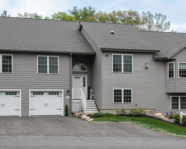 41 Winchester Dr, Hampstead, NH 03826 - view of front of house with an attached garage, a shingled roof, and driveway