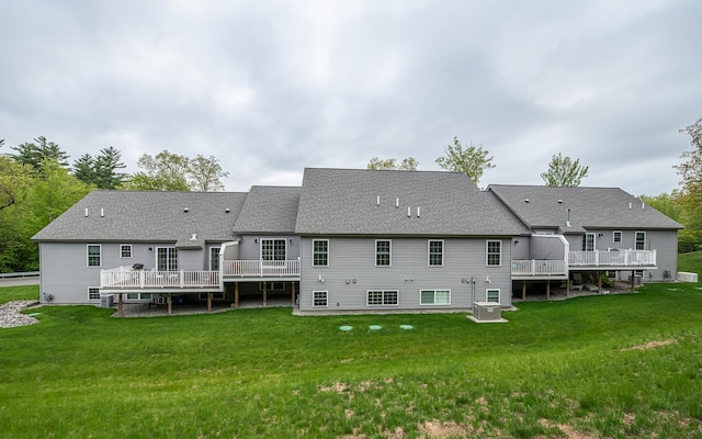 41 Winchester Dr, Hampstead, NH 03826 - back of property with a deck, a lawn, central AC unit, and a shingled roof