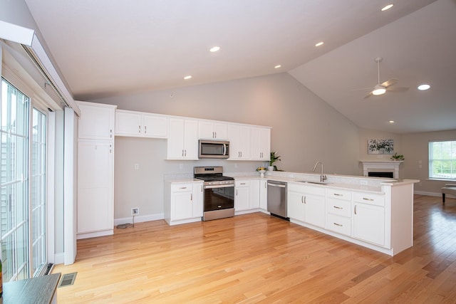 41 Winchester Dr, Hampstead, NH 03826 - kitchen with appliances with stainless steel finishes, a sink, a peninsula, vaulted ceiling, and open floor plan